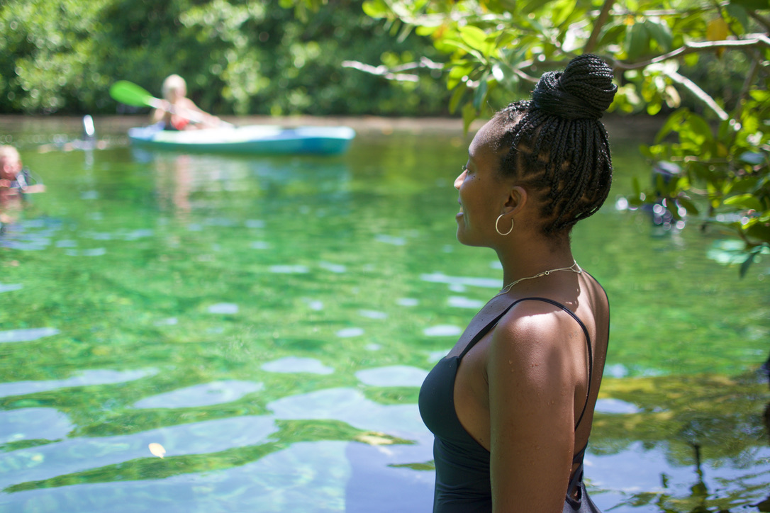 black girl looking over water at Casa Cenote