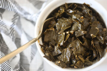 Vegan Collard Greens in white bowl with gold fork