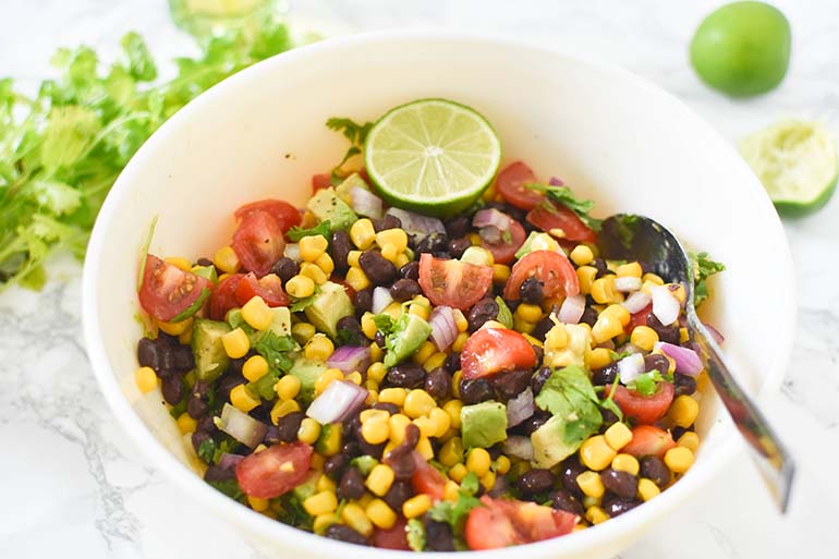 Avocado Black Bean Corn Salad in large  white bowl