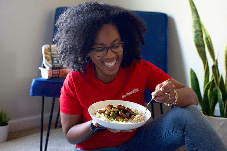 Women eating Vegan Honey Butter Garlic Chicken