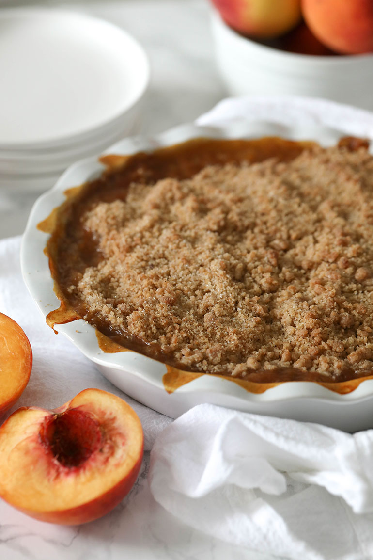 Vegan Peach Crisp in white dish