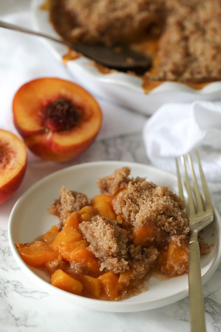 Vegan Peach Crisp on small white plate