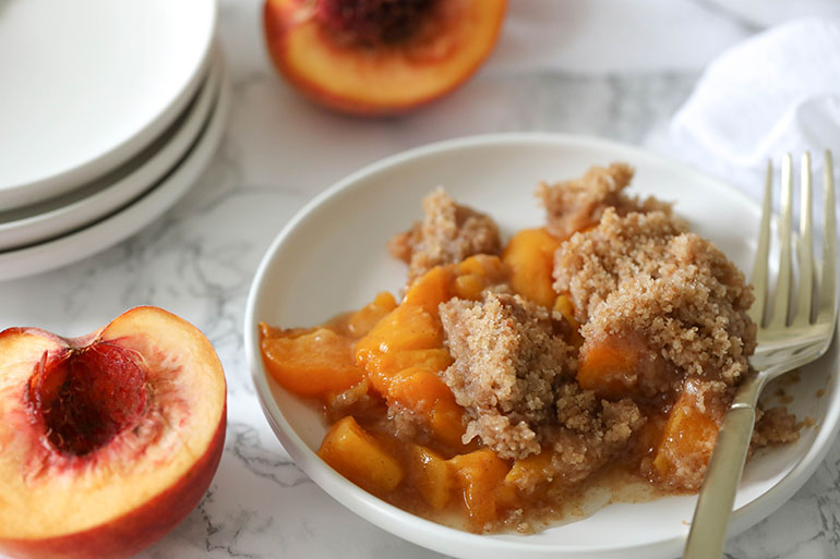 Vegan Peach Crisp on small white plate