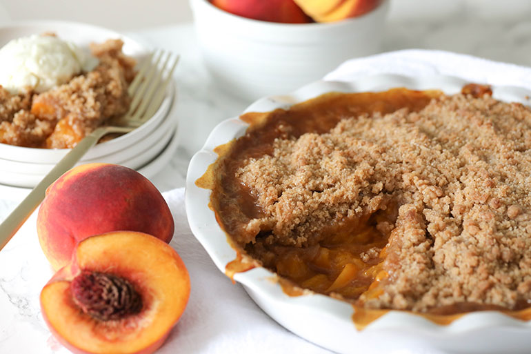 Vegan Peach Crisp in white dish