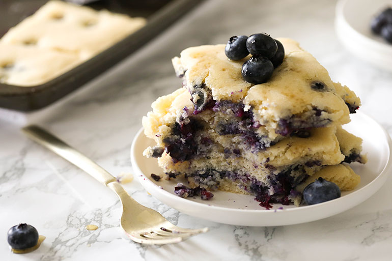 Vegan Blueberry Sheet Pan Pancakes with missing bite