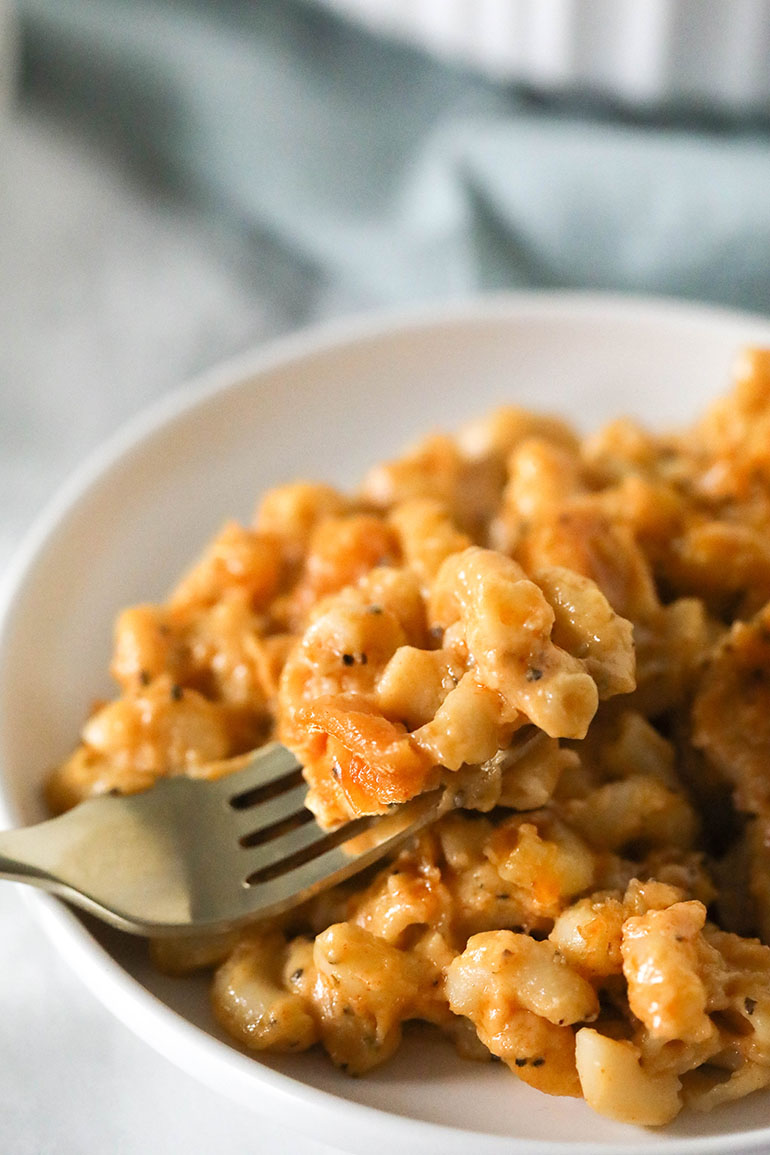 4 Cheese Vegan Baked Mac and Cheese with gold fork on white plate