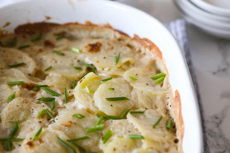 Vegan Scalloped Potatoes in white dish