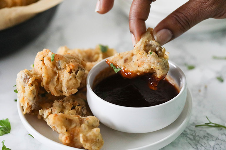 Fried Oyster Mushrooms with brown hand