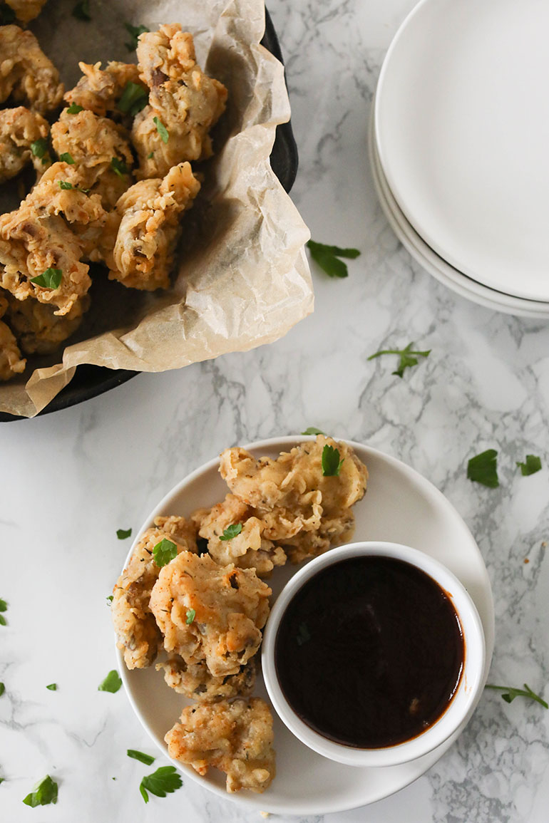 Fried Oyster Mushrooms on small plate with dipping sauce