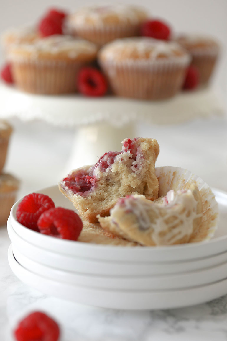 Vegan Raspberry Muffin on stack of white plates