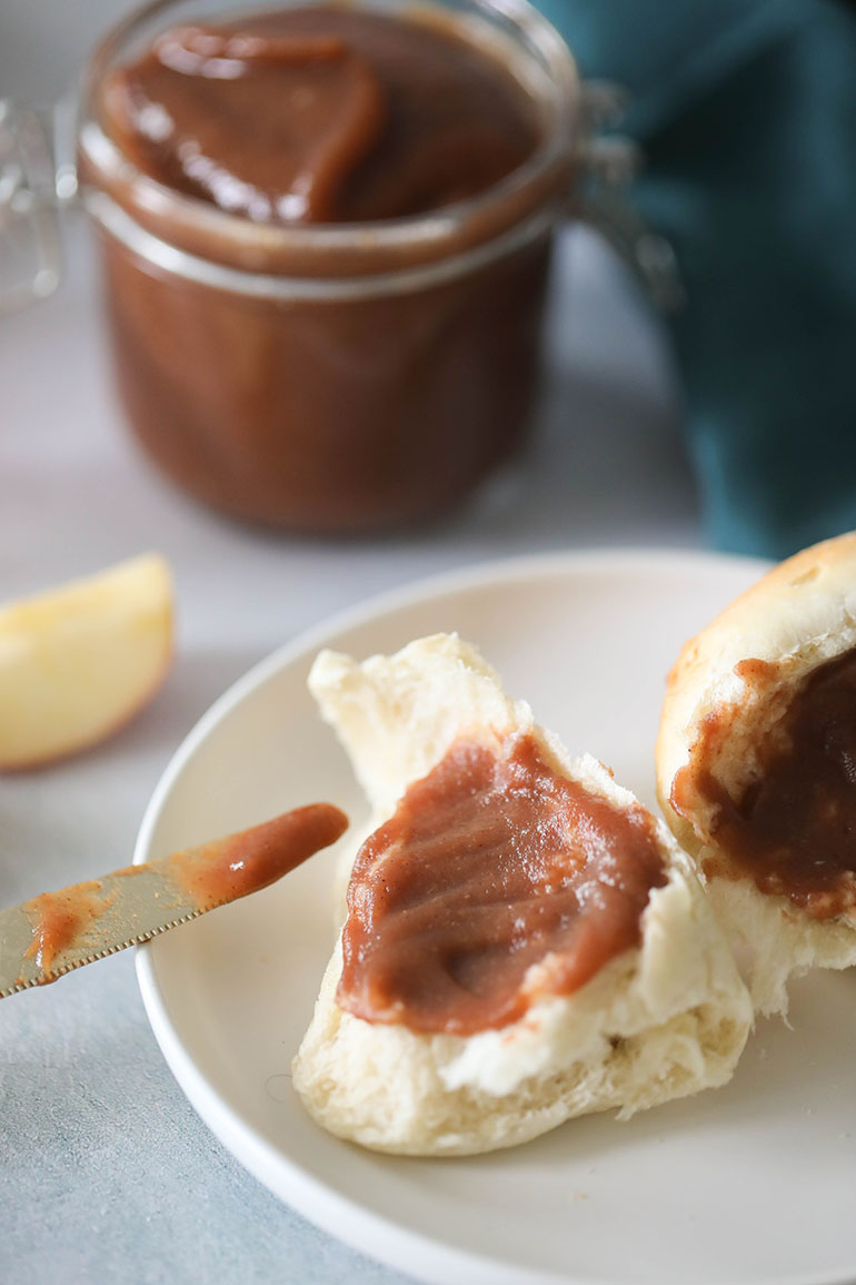 Slow Cooker Apple Butter spread over dinner roll