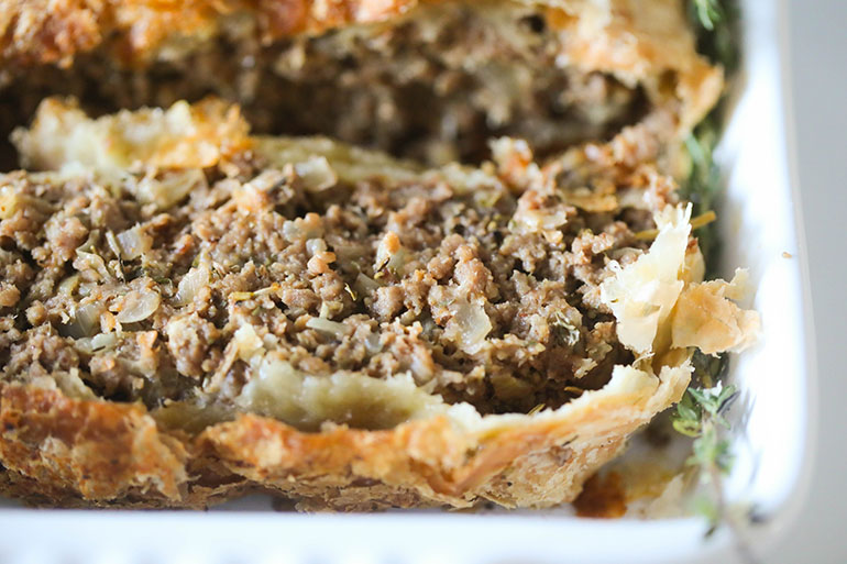 Sliced Vegan Beef Wellington in white dish