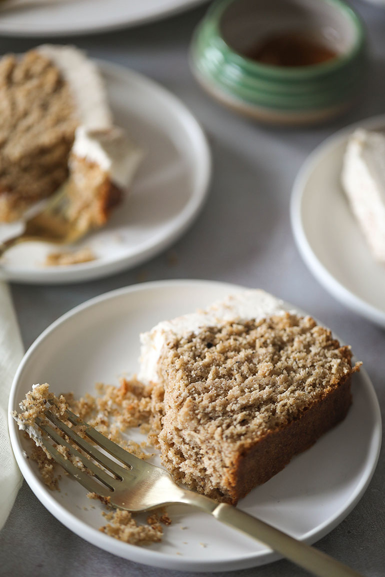 Sliced Vegan Gingerbread Loaf Cake on white plate with gold fork