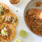 Vegan Refried Beans in pan with tacos